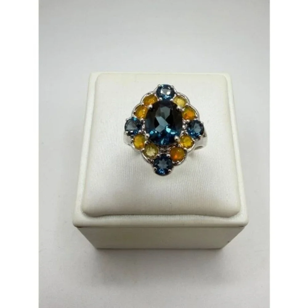 Stunning oval cut, faceted London Blue topaz and opal accent, 925 ring!